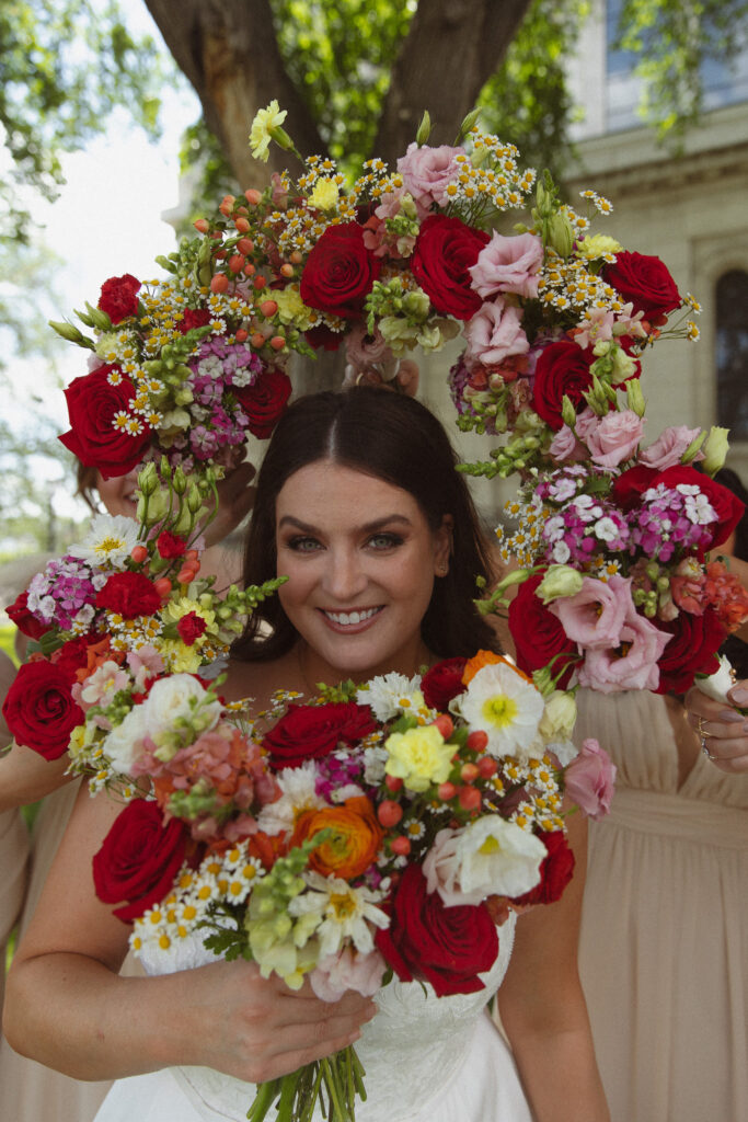 Colorful summer bouquets surrounding the Bride's face for her wedding portraits at The Basilica of St. Mary Church