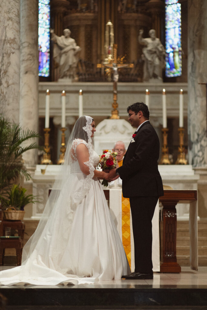 Bride and groom standing in front of the alter inside of the Basilica of St. Mary Church in Minneapolis 
