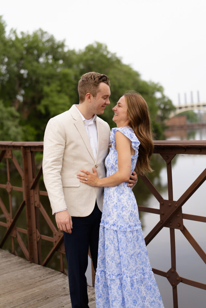 Engagement couple standing on the St Anthony Main bridge during their engagement photos