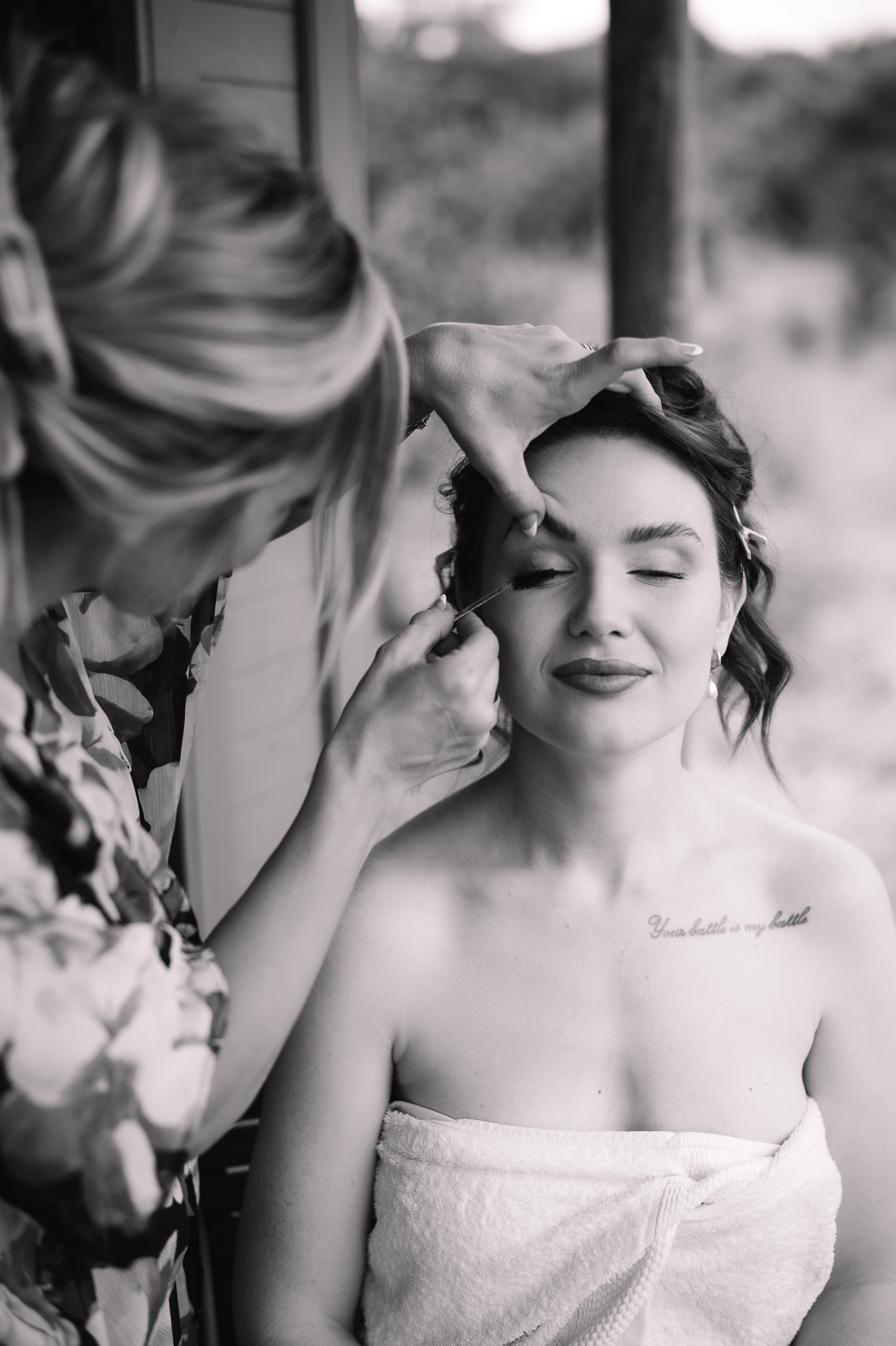 Safari elopement bride getting her make up done at her safari elopement suite