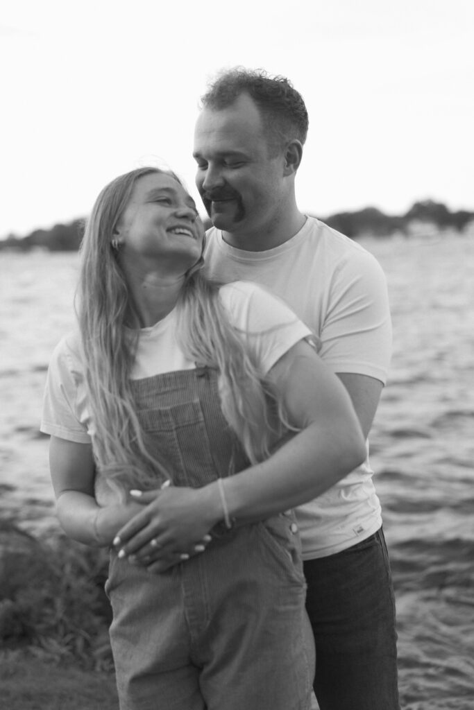 Couple holding each other laughing during their engagement photos in Excelsior