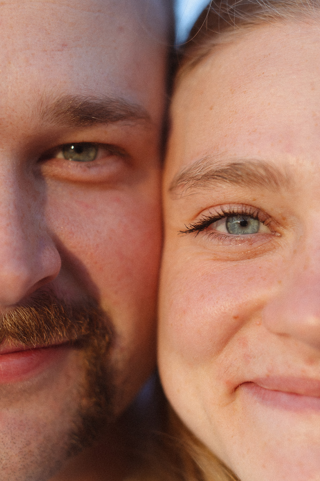 Close up shot of engagement couple's eyes as the sun shines on their faces