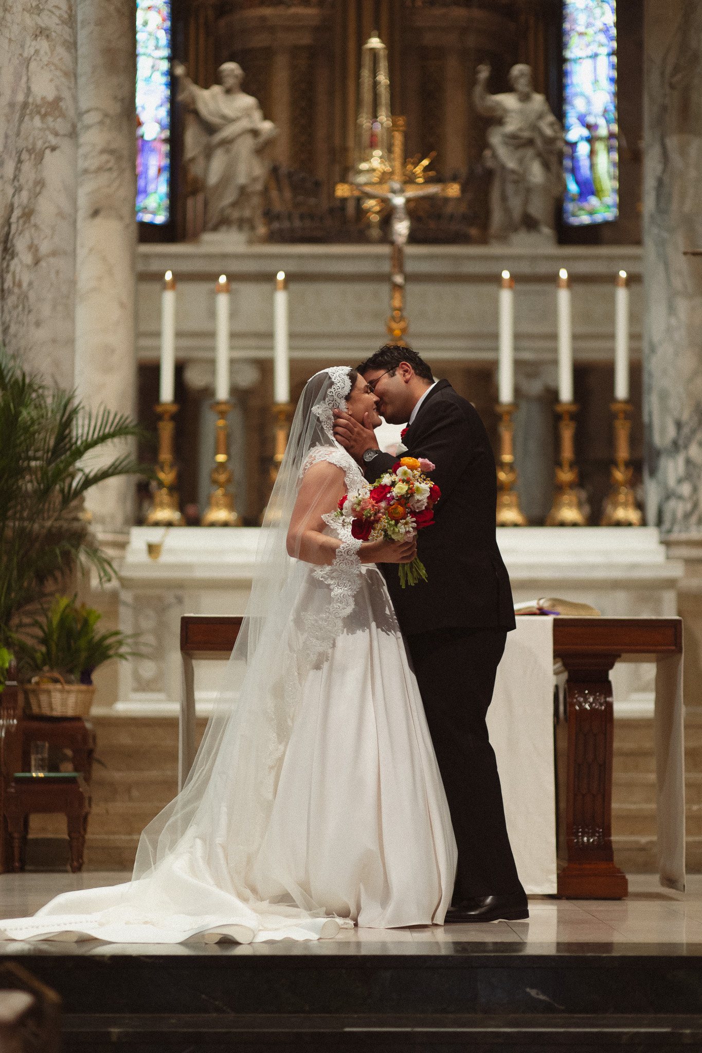 Bride and Groom having their first kiss at their wedding at the Basilica of St. Mary in Minneapolis