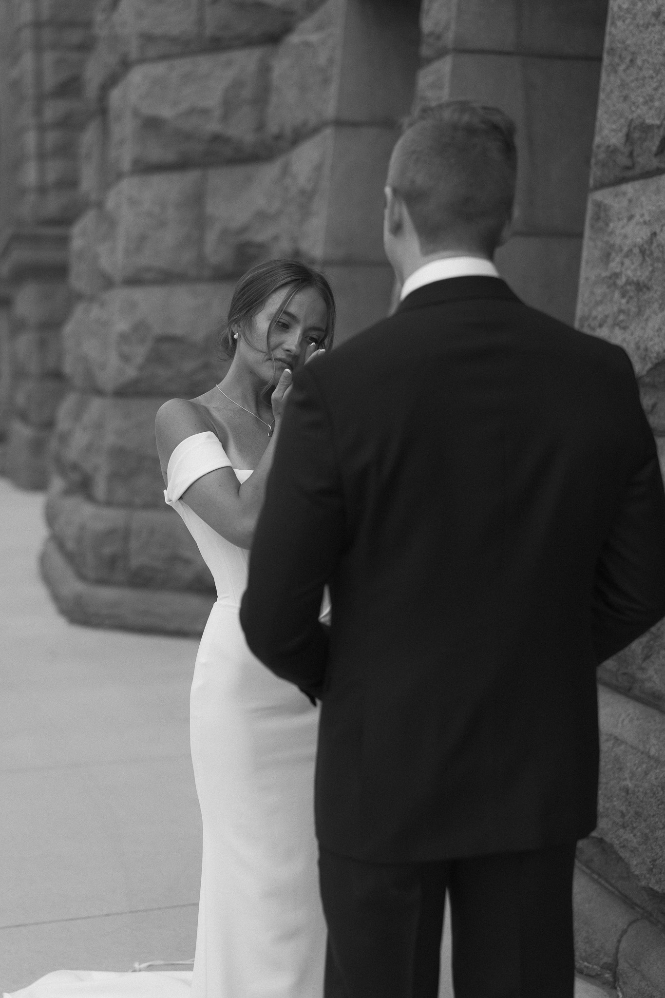 Bride wiping away a tear after her emotional private vows during their first look
