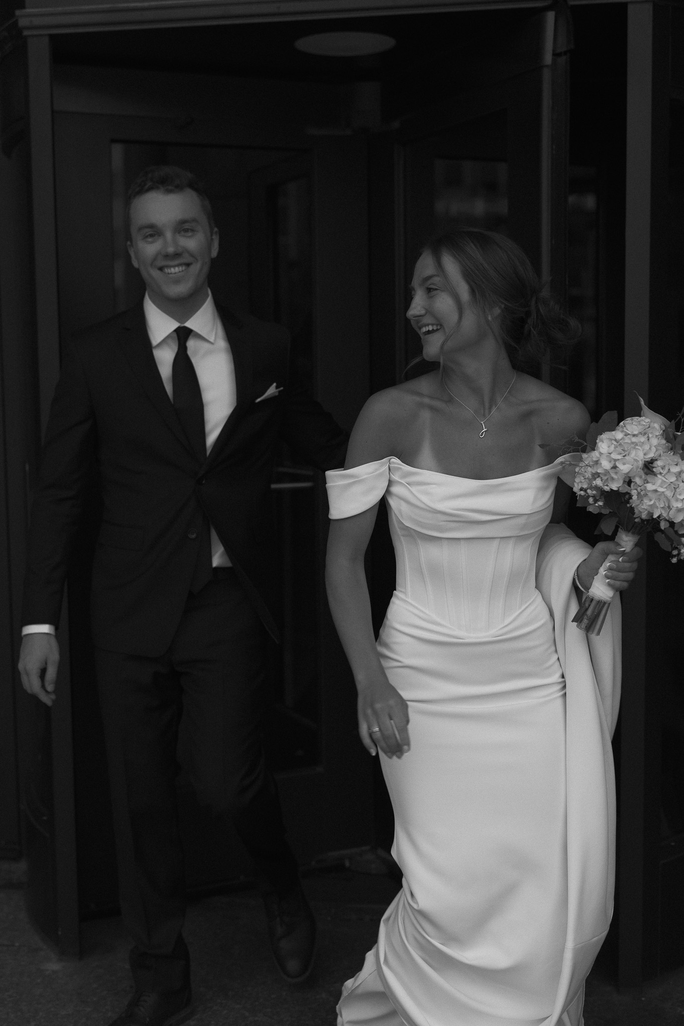 Documentary, cinematic photo of bride and groom walking together after their courthouse elopement in Minneapolis
