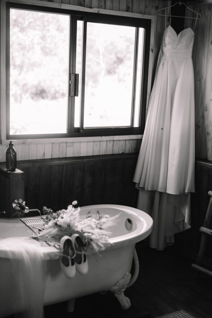 Safari elopement bathroom details of dress, shoes and bouquet 