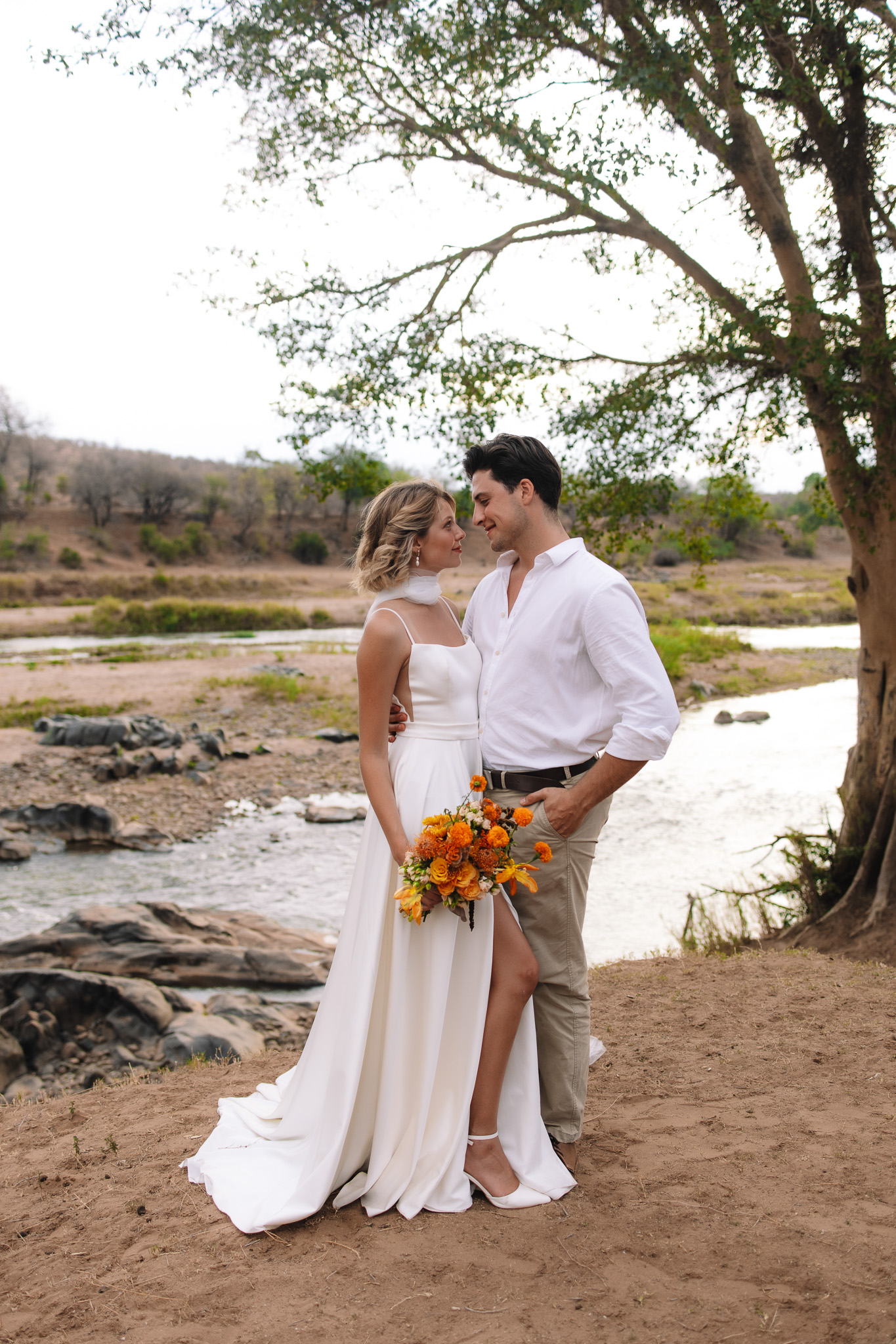Couple during golden hour on a safari game drive in Sabi Sands captured by South Africa safari elopement photographer