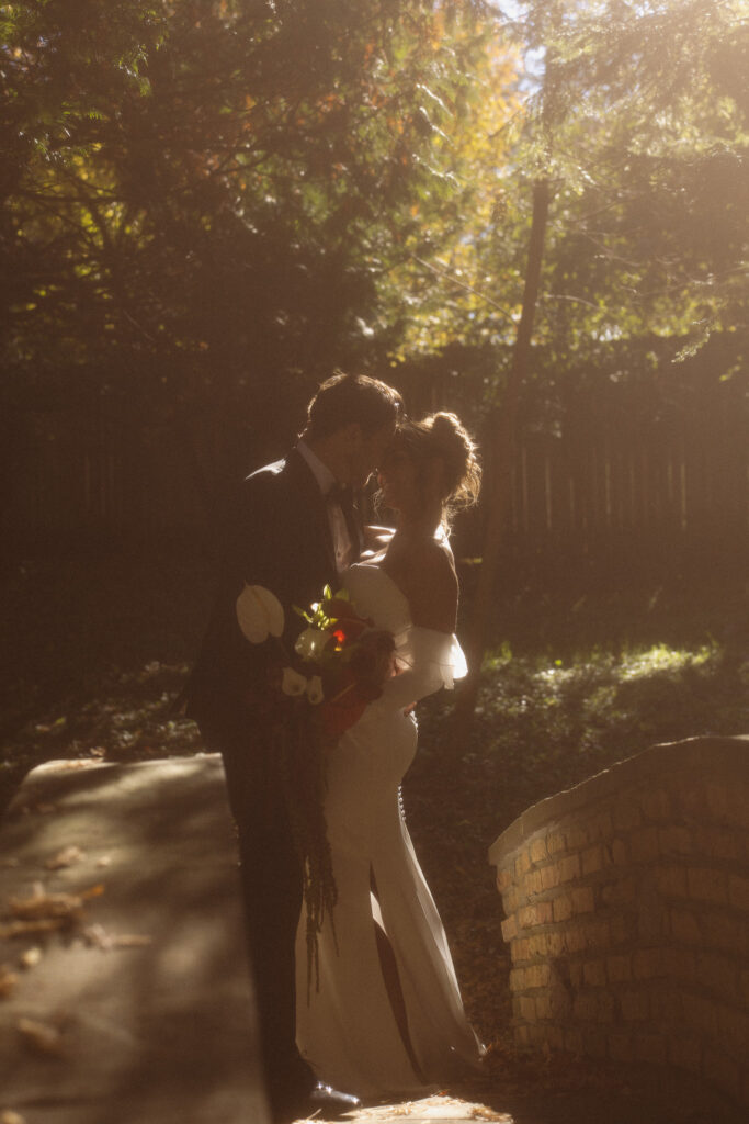 Bride and Groom portraits on the stone bridge at their Woods Retreat Wedding in Orono, MN