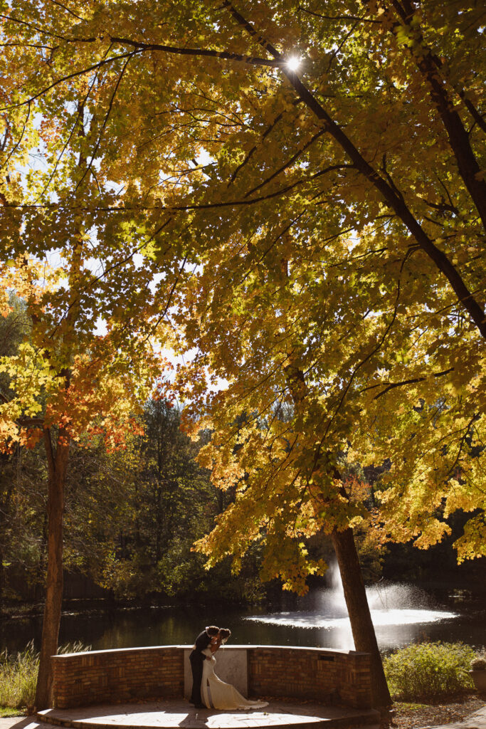Bride and Groom first kiss during their outdoor ceremony at The Woods Retreat wedding venue
