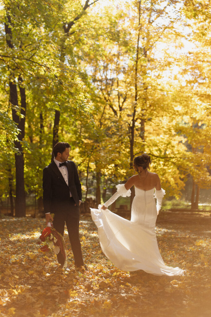Bride and Groom first look under the beautiful fall trees at The Woods Retreat Wedding venue in Orono