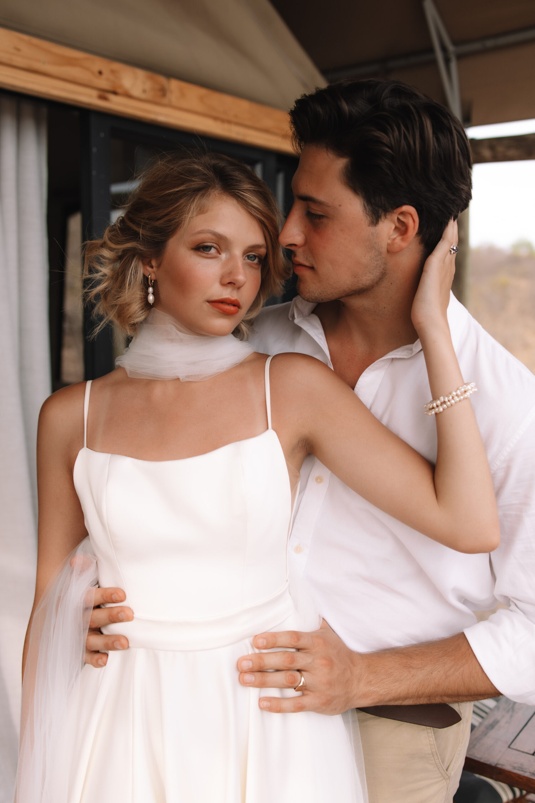 Bride and groom sharing an intimate moment on a safari lodge deck during a luxury South Africa safari elopement