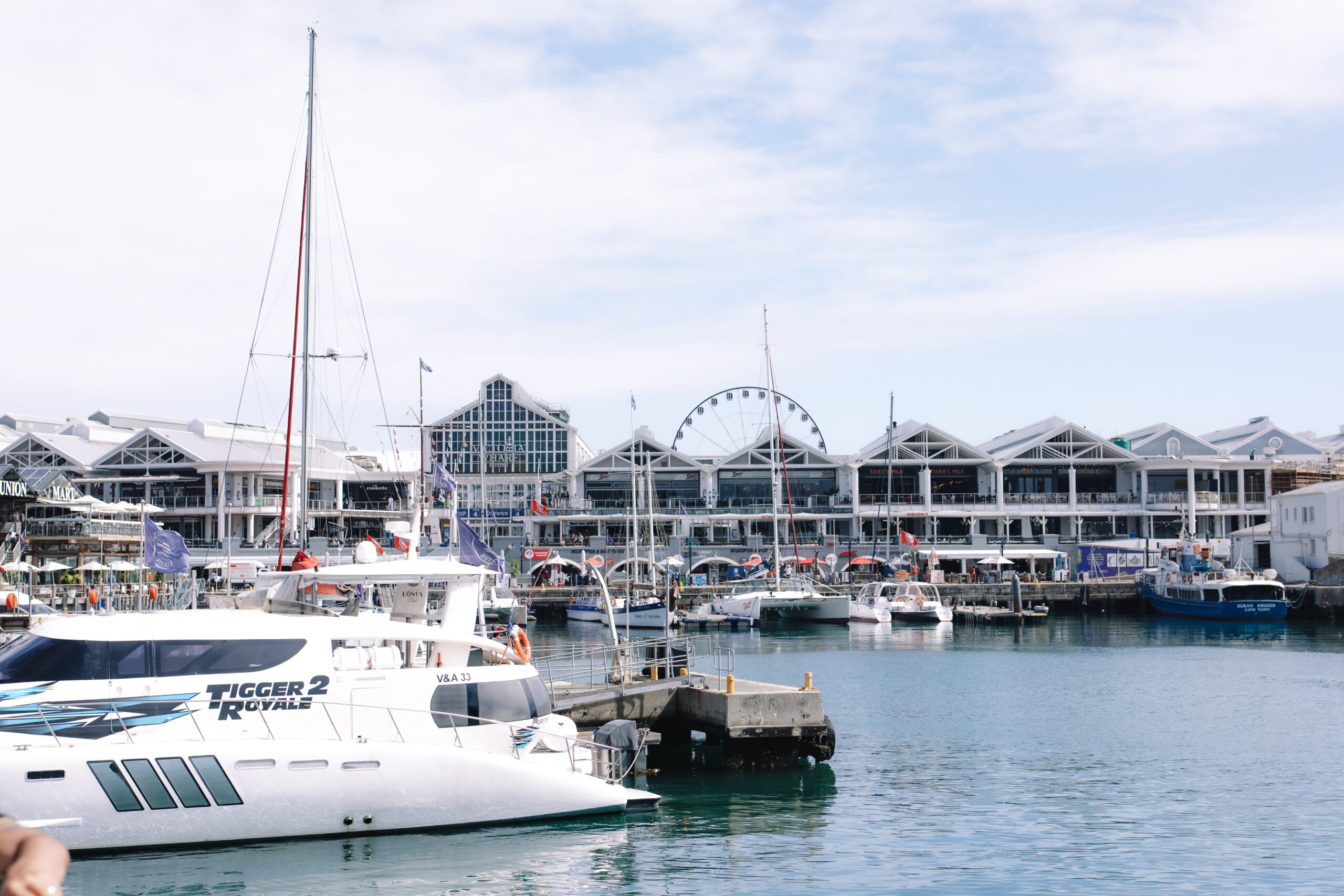 Wide harbor view with boats and waterfront buildings, capturing the relaxed coastal atmosphere of Cape Town on a clear day.