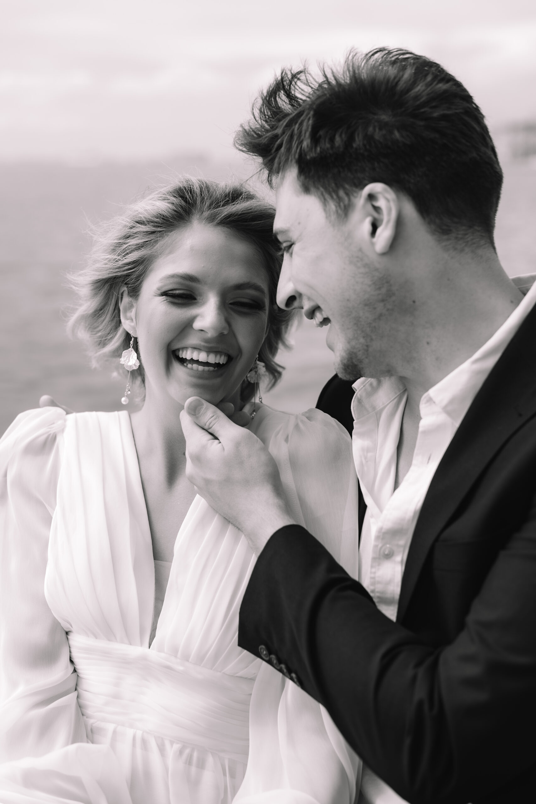 Joyful couple laughing together during their coastal elopement in Cape Town.