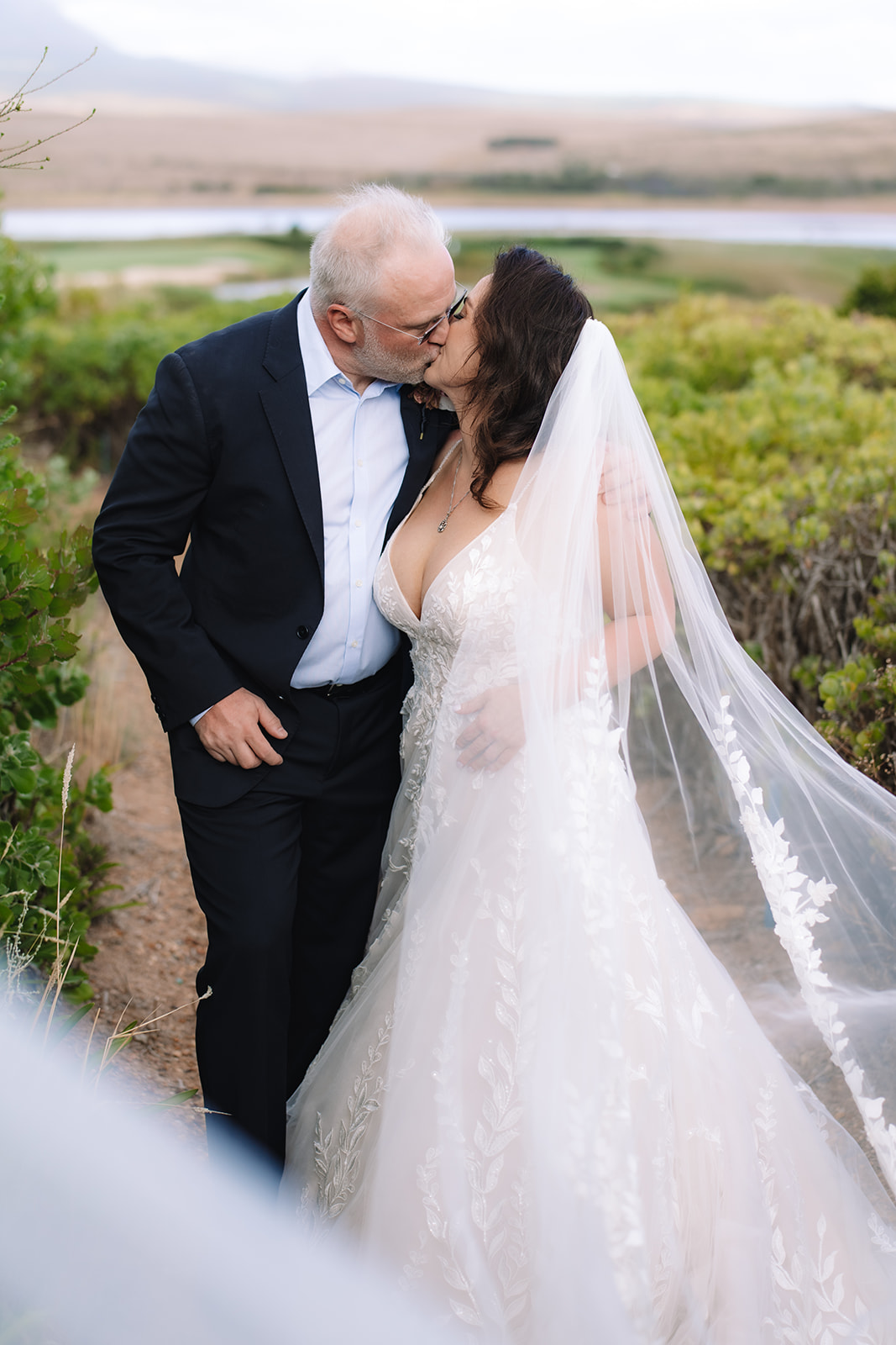 Newlyweds kissing during a Cape Town elopement along the Betty’s Bay coastline