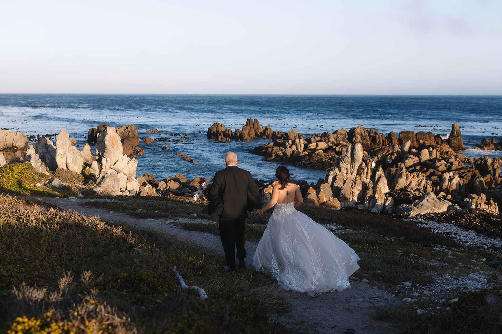 Couple exploring the coastline after their stony point nature reserve wedding