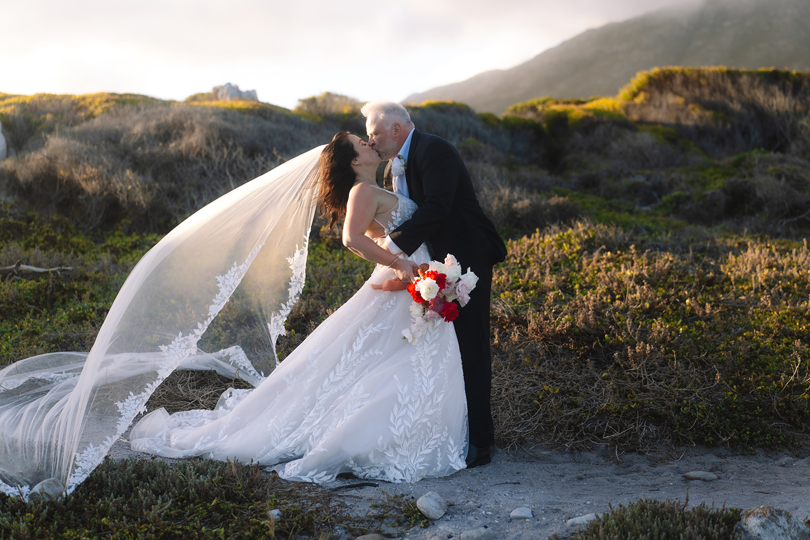 Golden hour kiss during a stony point nature reserve wedding in Betty’s Bay