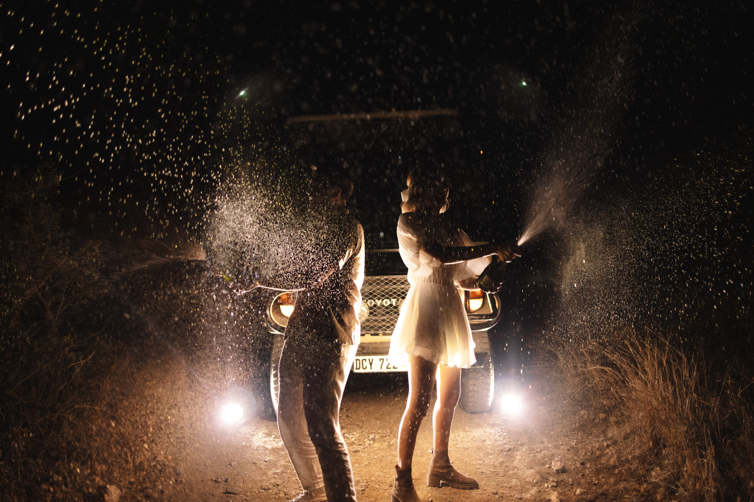 Couple celebrating at night in the bush during their luxury safari elopement in South Africa.