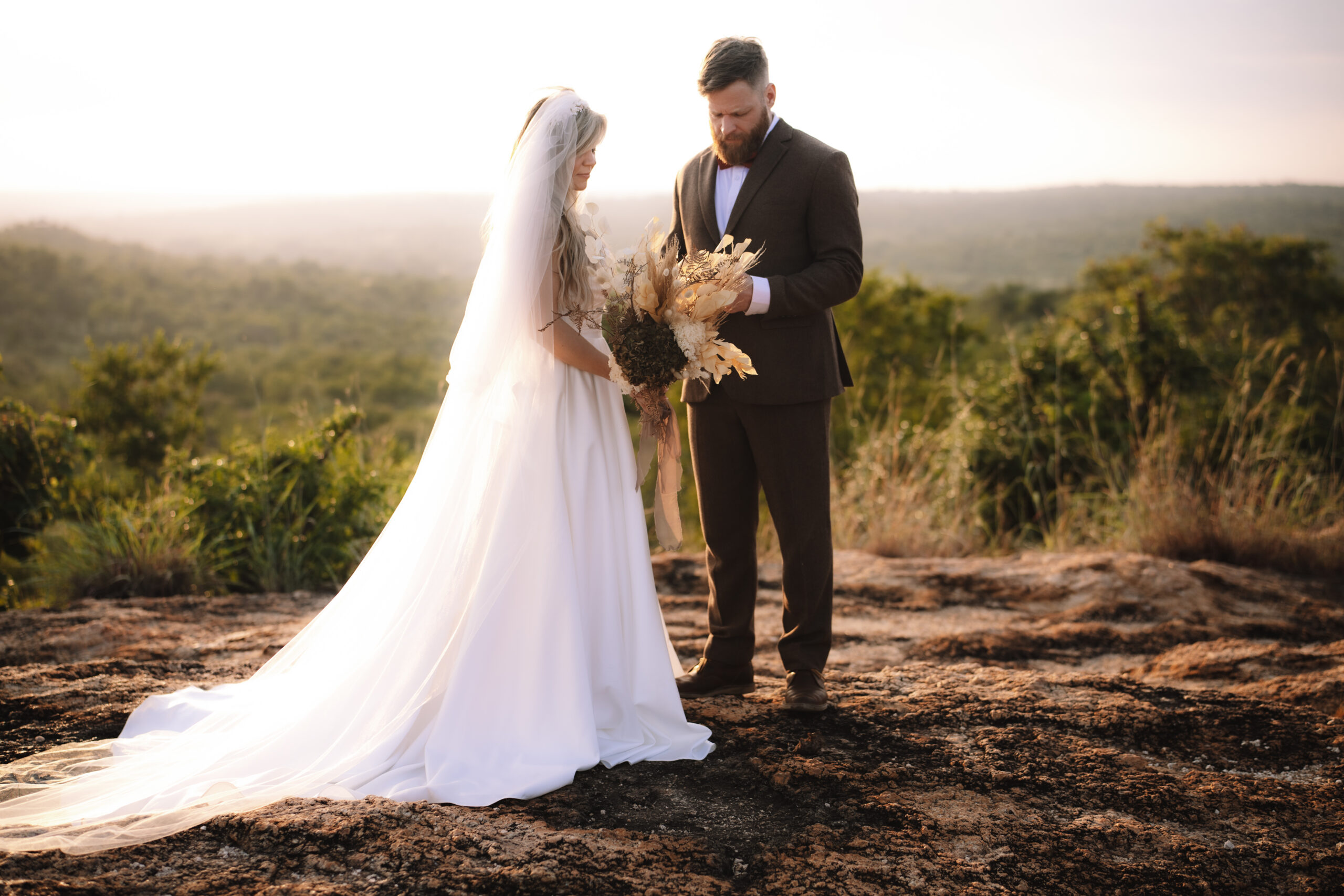 Bride and groom on a scenic overlook during their Cape Town honeymoon safari.
