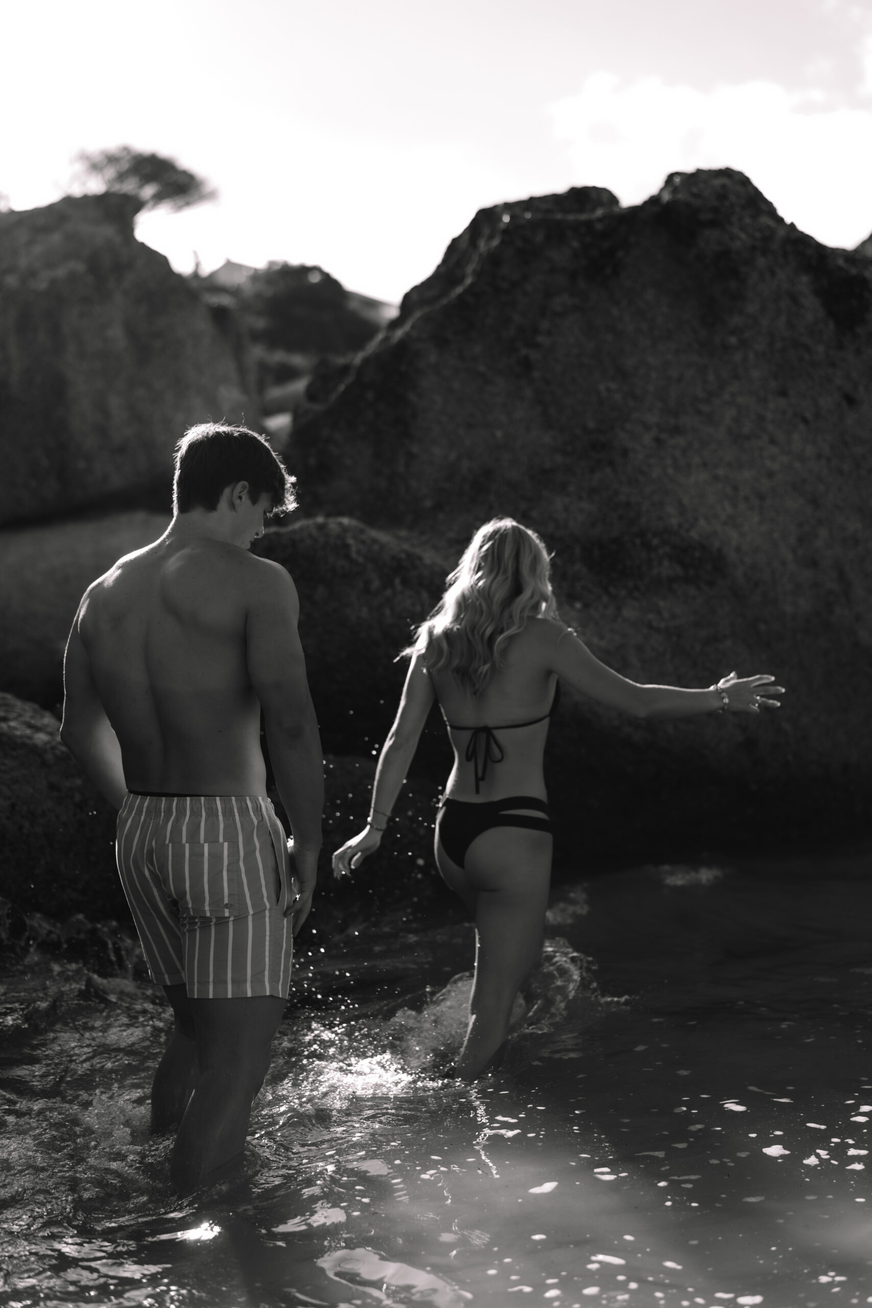 Couple wading into the ocean during their Cape Town honeymoon adventure session.