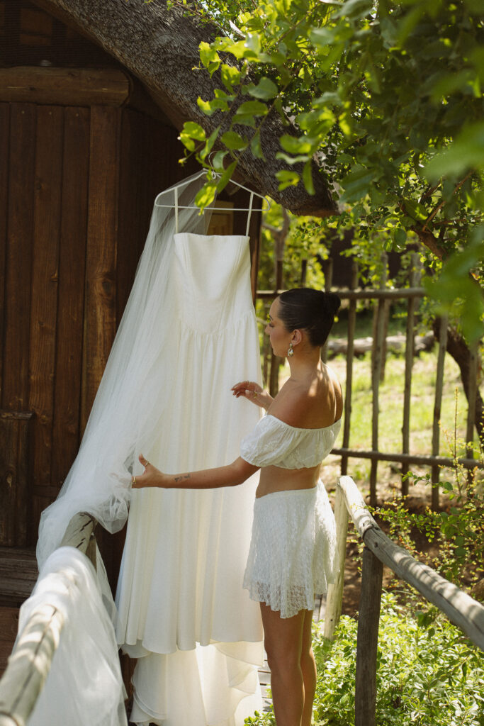 Cassidy looking at her wedding dress outside her safari lodge suite in Sabi Sands