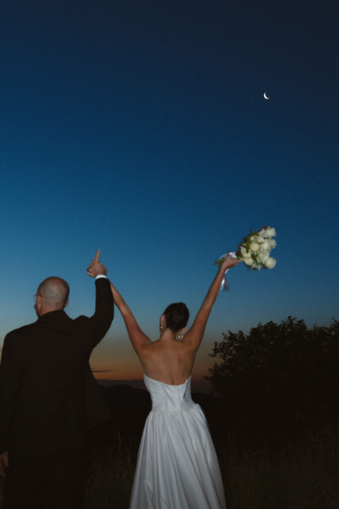 Cassidy and Charlie celebrating after their Sabi Sands safari elopement at blue hour