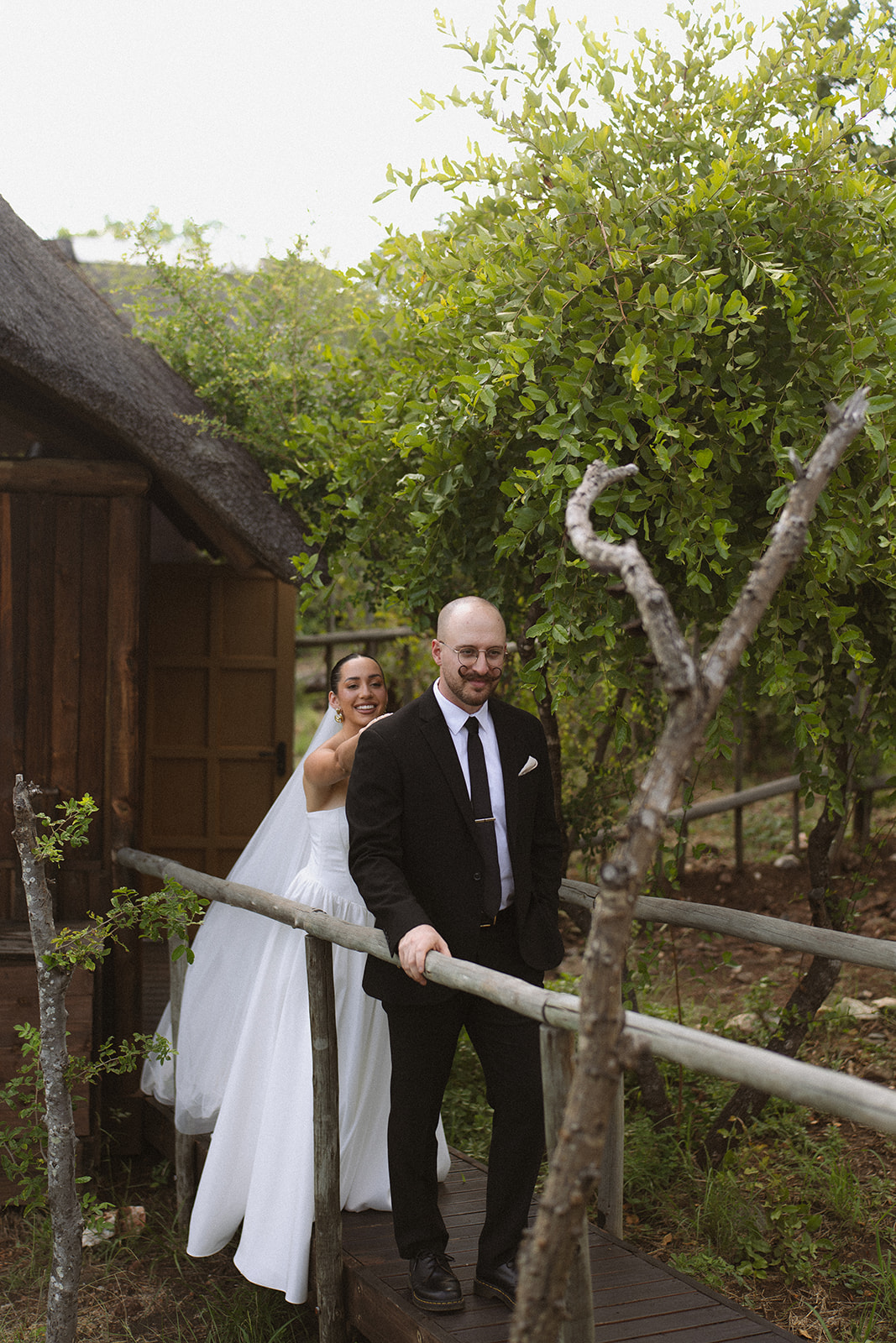 Bride surprising groom during first look outside safari lodge before they elope in South Africa
