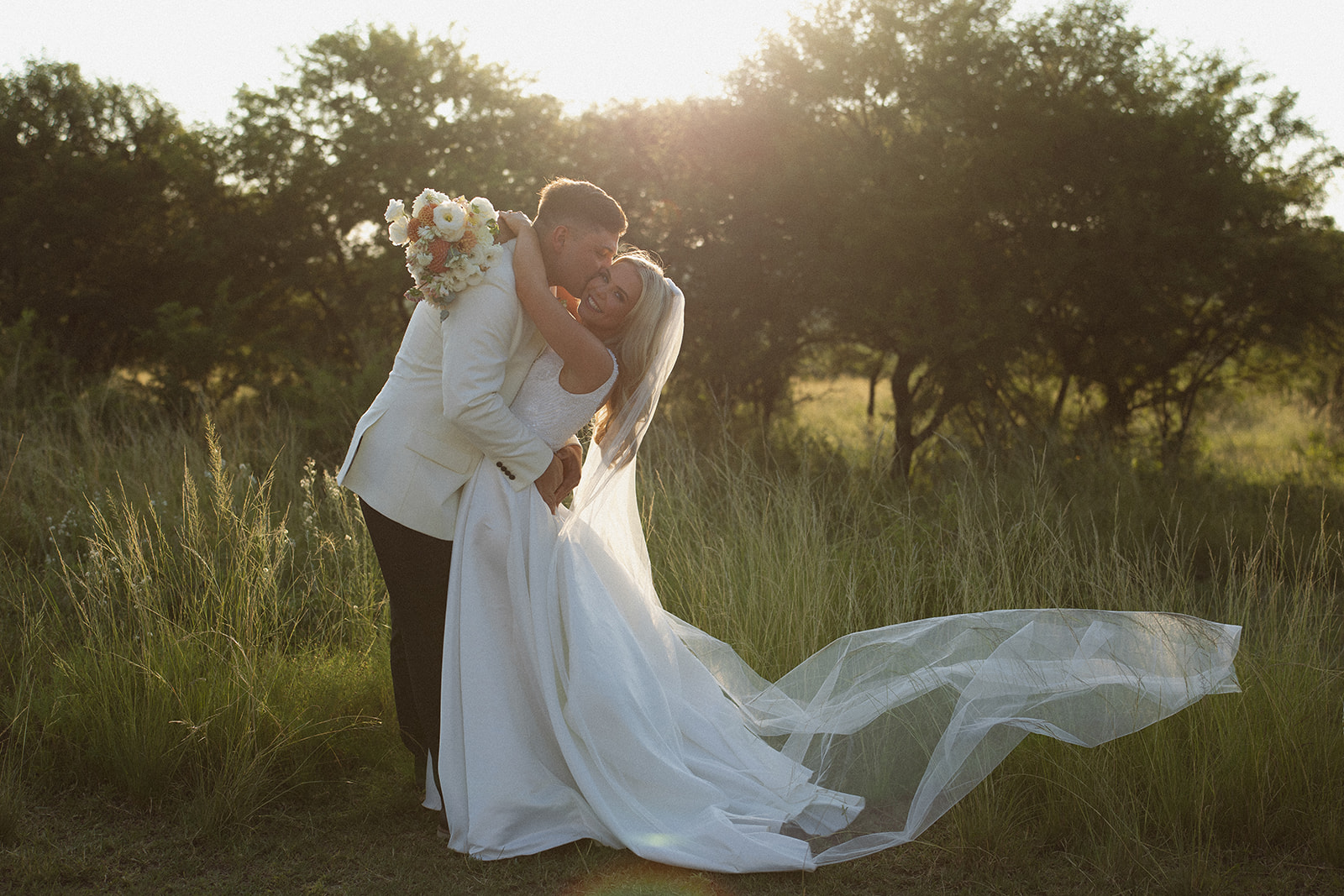 Bride and groom embracing in golden light during a safari wedding in South Africa