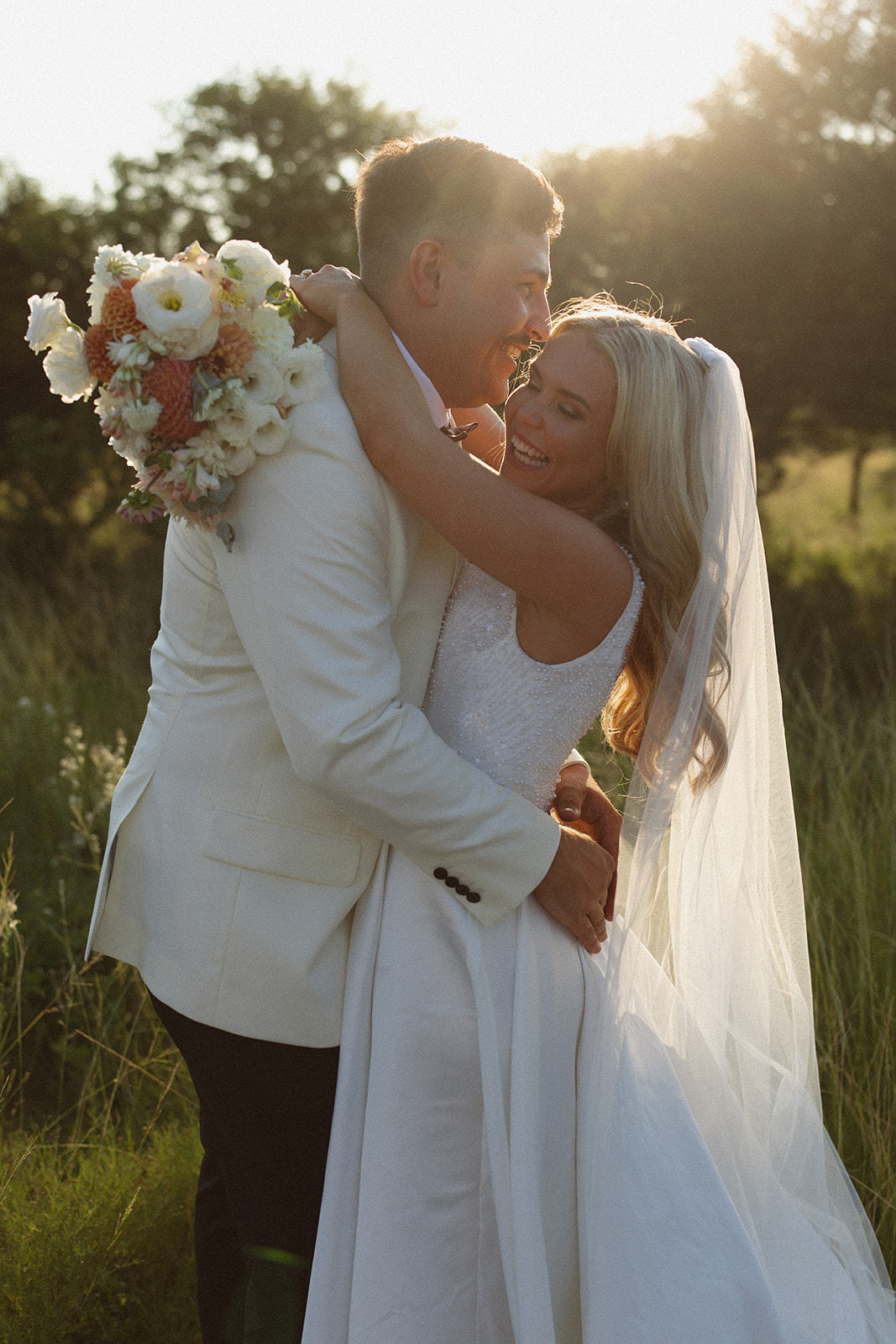 Bride and groom embracing in soft sunset light during a safari wedding in South Africa