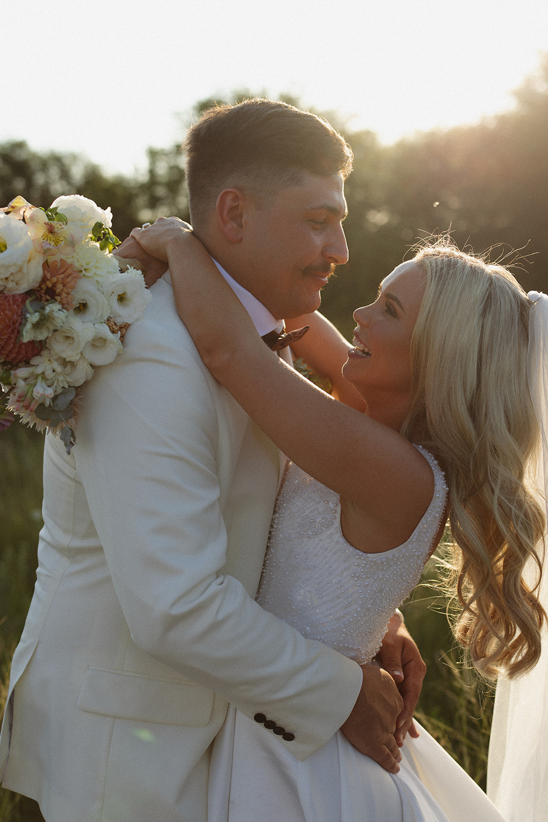 Bride and groom embracing in golden light during a safari wedding in South Africa