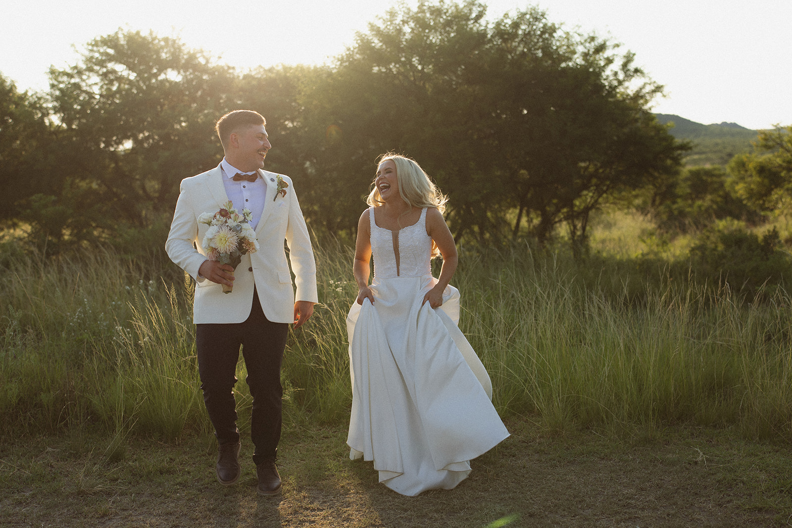 Bride and groom walking together at sunset during a safari wedding in South Africa