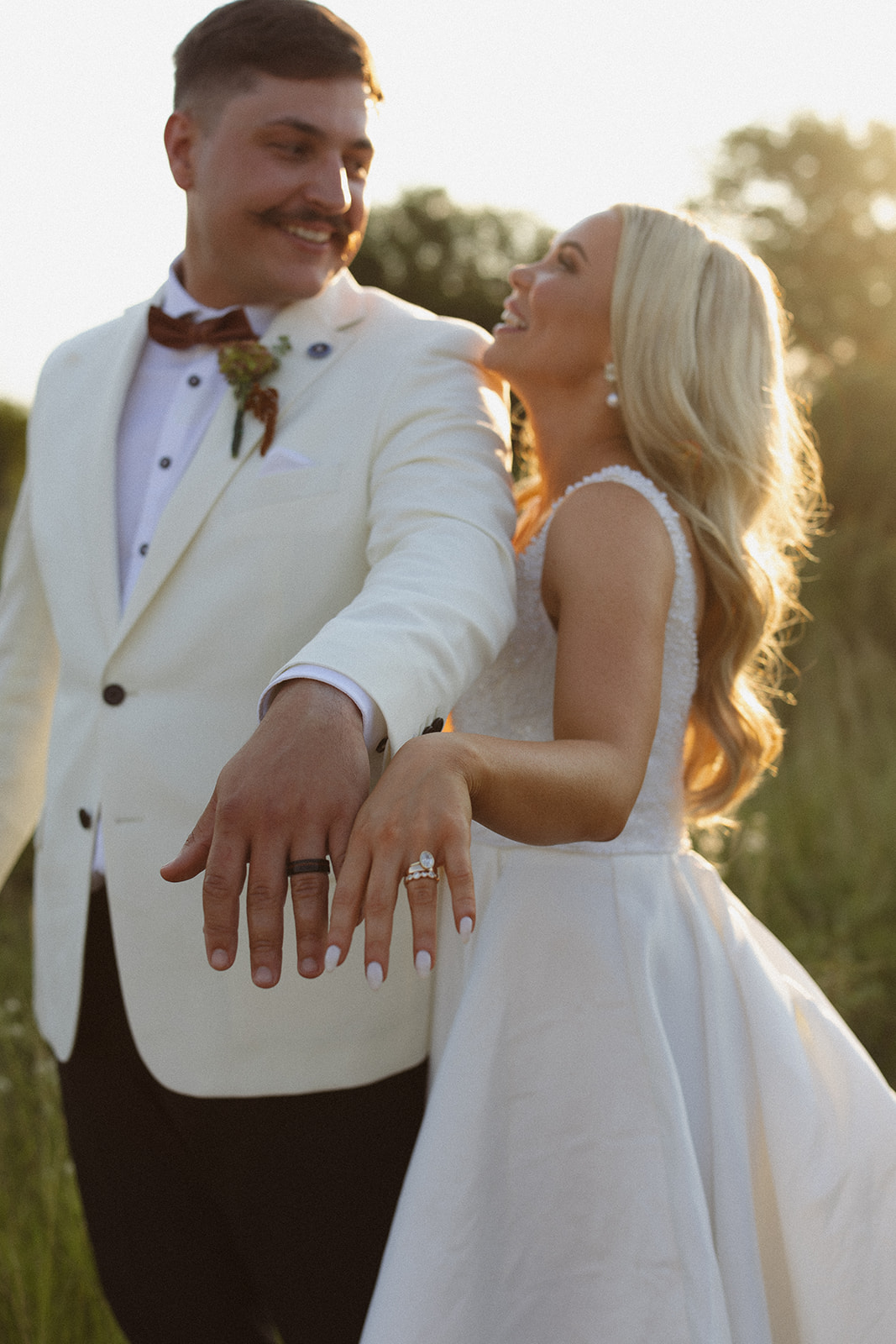 Bride and groom showing wedding rings during golden hour at a safari wedding in South Africa