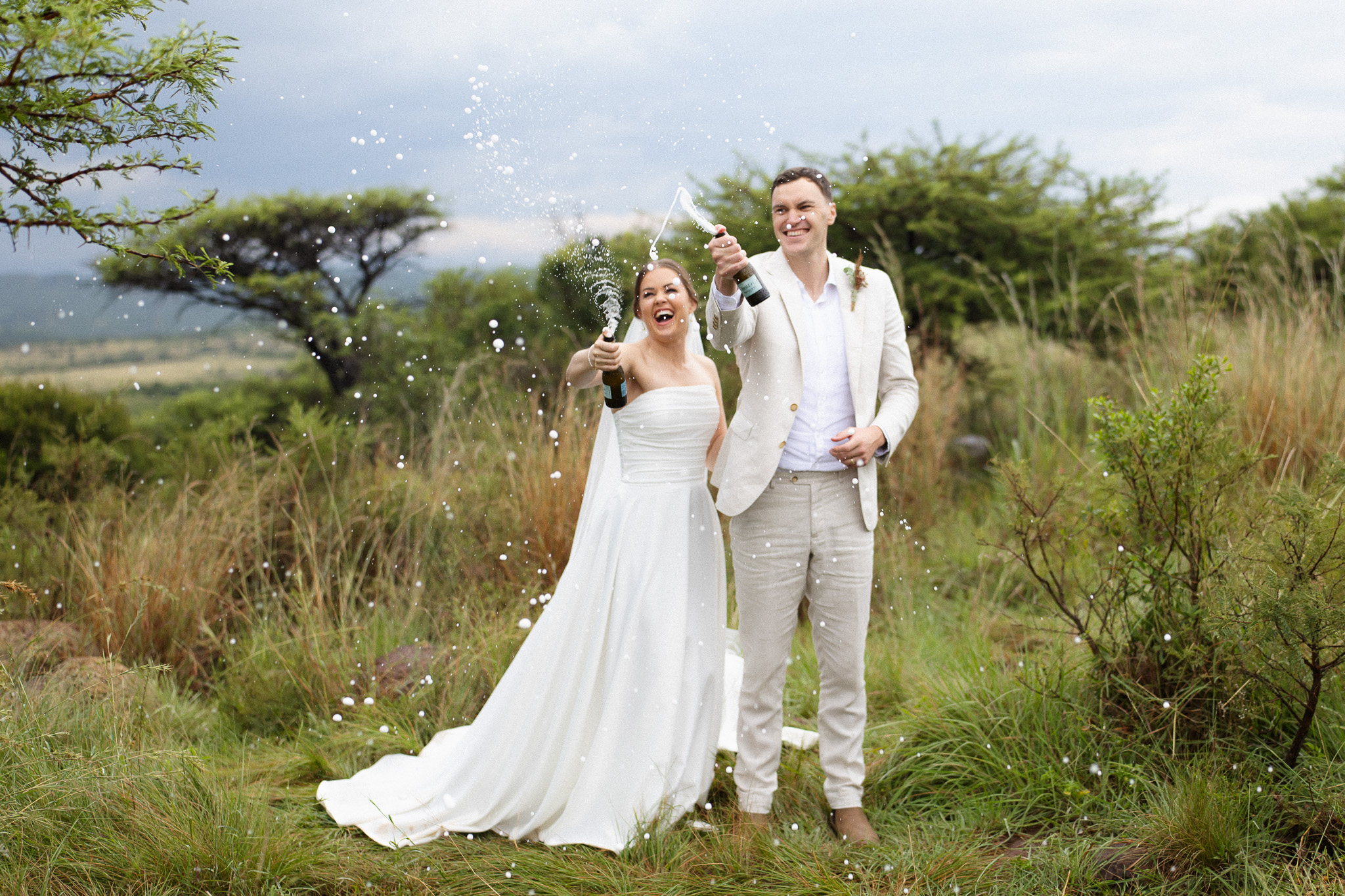 Shay and Larissa spraying champagne after their legal safari wedding ceremony at Nambiti Hills