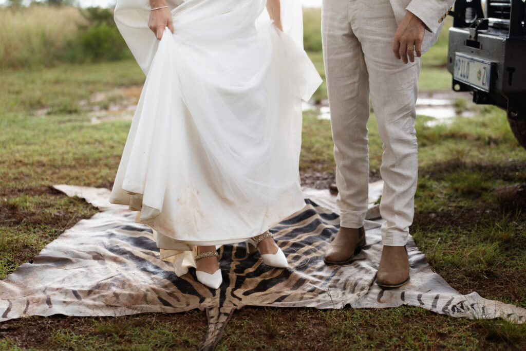 Shay and Larissa standing on a safari-style hide rug during their legal wedding ceremony at Nambiti Hills