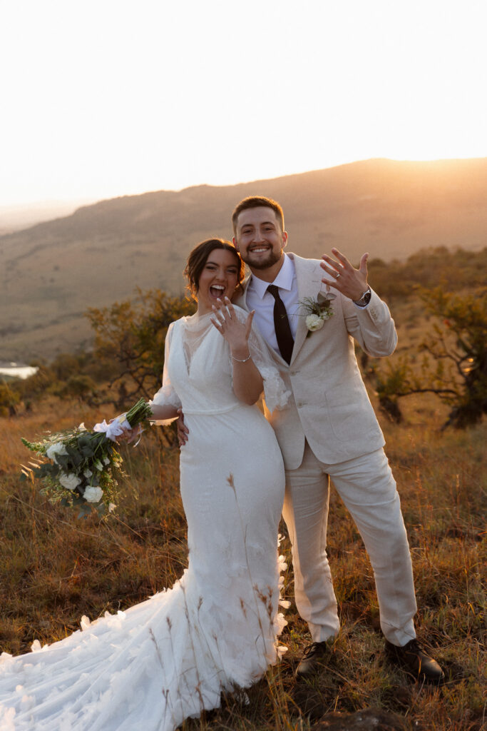Matt and Izzy showing their wedding rings after their intimate safari ceremony in Babanango