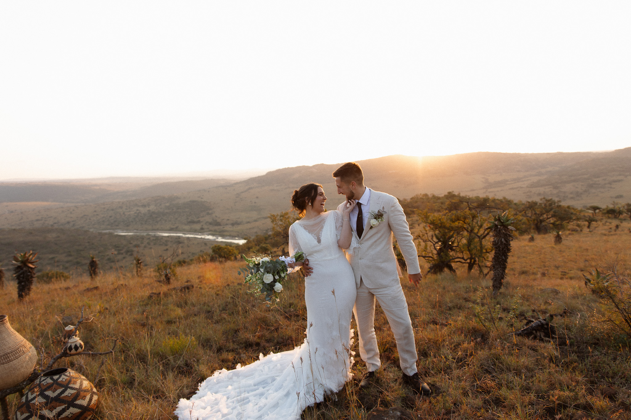 Bride and groom standing together at sunset during their intimate safari wedding in South Africa